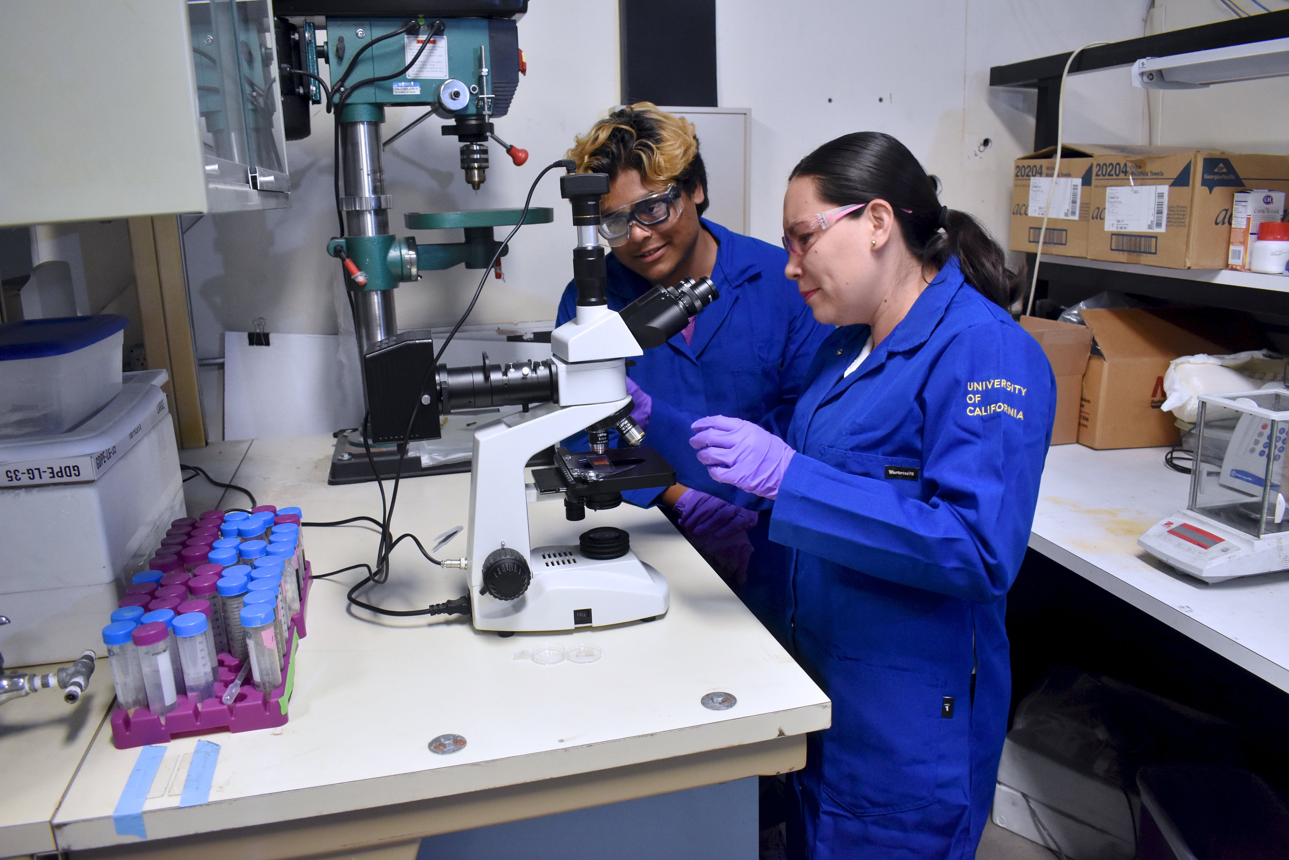 A researcher works with solar energy and electrical systems equipment at a UC Riverside renewable energy research facility.