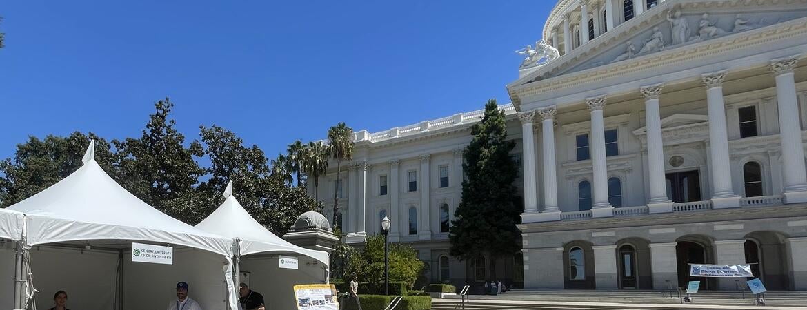 CE-CERT exhibit booth outside the California State Capitol in Sacramento, with representatives and research displays set up in front of the Capitol building.