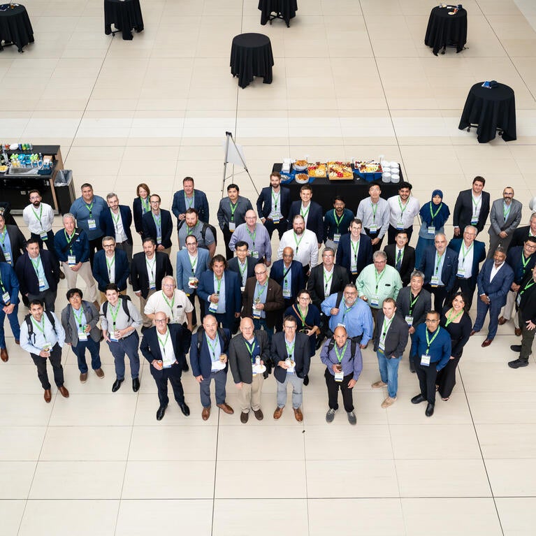 Attendees of the Fall 2026 North American Hydrogen Engine Conference gather for a group photo in the atrium at Huntington Place in Detroit.