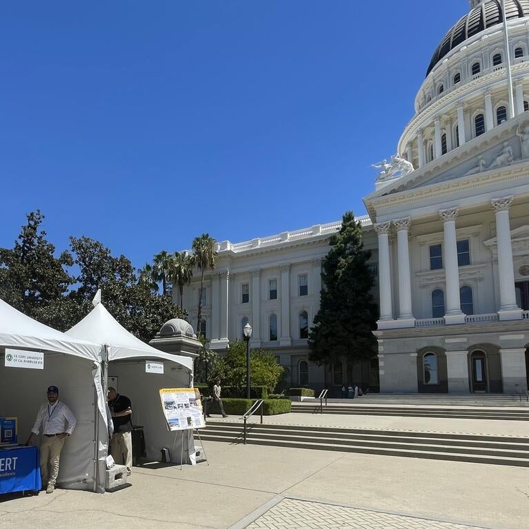 CE-CERT exhibit booth outside the California State Capitol in Sacramento, with representatives and research displays set up in front of the Capitol building.