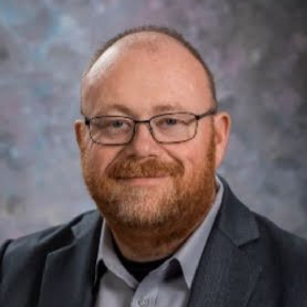 michael brown man with beard and glasses wearing suit