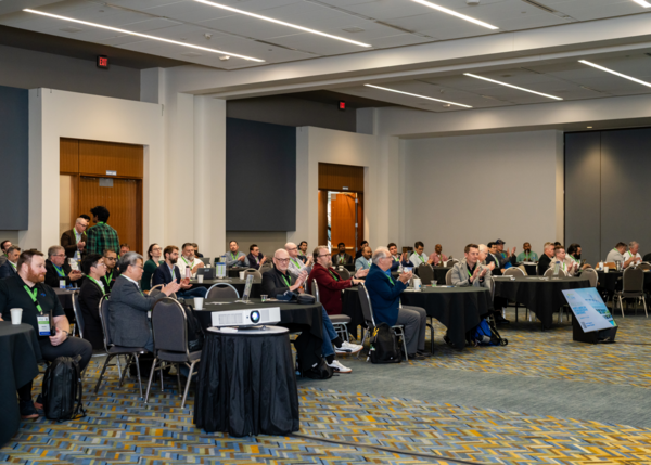 Attendees at the Fall 2026 North American Hydrogen Engine Conference sit at tables and applaud during a session at Huntington Place in Detroit.