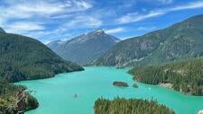 photo of mountains and icy blue lake