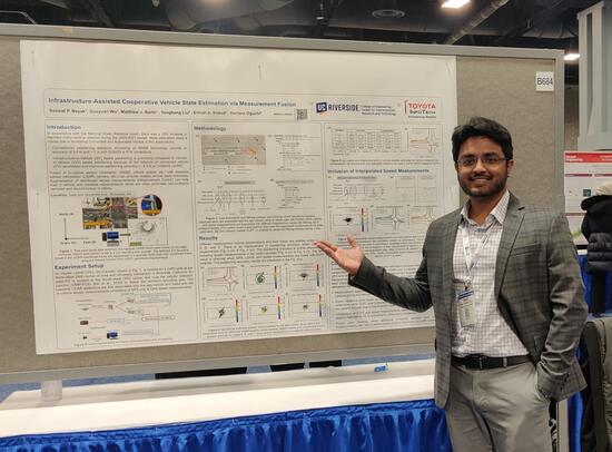 CE-CERT Students stands in front of his poster to present his research at TRB