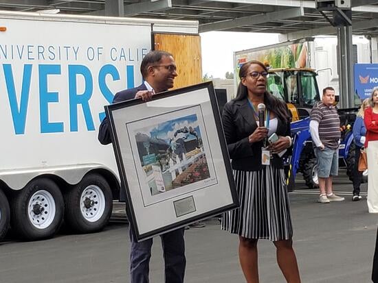 Associate Director of Operations, Arun Raju and Bay Area AQMD Member Davina Hurt presenting artwork dedicated to air quality. CARB has the largest permanent art collection addressing climate change. 